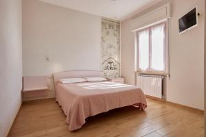 a white bedroom with a bed and a window at La Camelia Bianca B&B in Lerici +47 photos