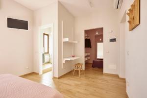 a bedroom with a bed and a desk in a room at La Camelia Bianca B&B in Lerici