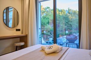 a bedroom with a bed with a view of a balcony at Monarco Executive Rooms in Rhodes Town +40 photos
