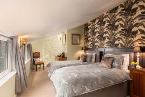 a bedroom with two beds and a wall mural at Pilgrim Corner in Minehead