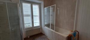 a bathroom with a tub and a window with shutters at Le Clos du Bohon, 90m2 , calme dans l'Oise ,15 mn de Gisors et son chateau in Labosse +15 photos