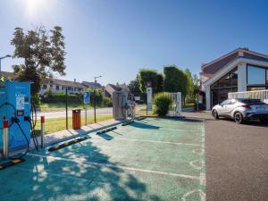 a car is parked in a parking lot at a gas station at ibis Cergy Pontoise Le Port in Cergy