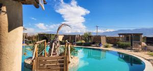 a swimming pool with a mountain in the background at Dar Tiziri Amizmiz in Marrakesh