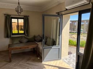 a sliding glass door with a bench in a room at Dar Tiziri Amizmiz in Marrakesh +50 photos