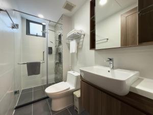 a white bathroom with a sink and a toilet at CityHouse TERA The S in Ho Chi Minh City +50 photos