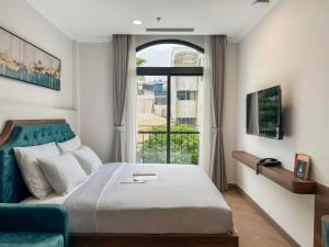 a bedroom with a bed and a large window at CityHouse TERA The S in Ho Chi Minh City
