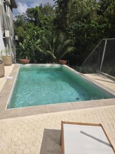 a swimming pool with blue water in a backyard at Jean Olive in Castries