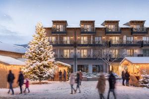 a group of people walking in the snow in front of a building at Engels Traumwerk in Wertach