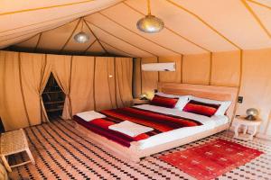 a bedroom with a bed in a tent at Platinum Heritage Desert Camp in Jaisalmer