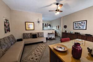 a living room with a couch and a table at CASA 230 - Guest House in Piracicaba