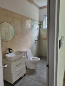 a bathroom with a sink and a toilet and a mirror at Mountain view villa in Vang Vieng