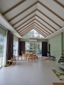 a large room with tables and chairs and a large window at Mountain view villa in Vang Vieng +46 photos