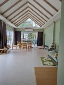 a living room with a table and chairs at Mountain view villa in Vang Vieng