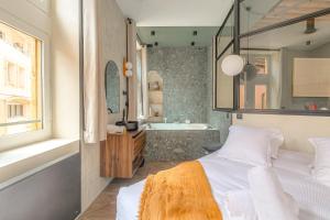 a bedroom with a bed and a tub and a sink at LaBolla, charmant cocon avec spa, cœur de Lyon in Lyon +46 photos