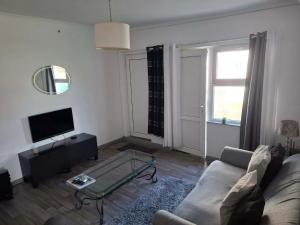 a living room with a couch and a glass table at Bellas place in Yambol