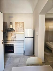 a kitchen with a refrigerator and a stove at La Guglia - Maison à Porter in Vasto