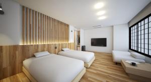 a hotel room with two beds and a tv at New Grand Hotel in Shinjo +14 photos