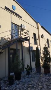 a building with a balcony on the side of it at Немирівель in Nemirov