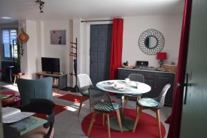 a living room with a table and chairs at Gite le GINKGO 50 M2 in Rougegoutte