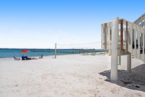 a volleyball court on a beach with a volleyball net at Sound-Side Condo with Grill Deck & W&D and Shared Pool in Pensacola Beach