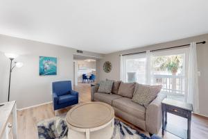 a living room with a couch and a table at Sound-Side Condo with Grill Deck & W&D and Shared Pool in Pensacola Beach +17 photos