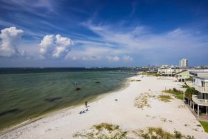 an overhead view of a beach with people in the water at Third-floor beachfront condo with views washer&dryer heated pool in Pensacola Beach