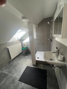 a bathroom with a sink and a bath tub at Bright and modern Apartment in Gröbenzell
