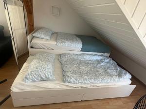 two beds with pillows on them in a room at Bright and modern Apartment in Gröbenzell