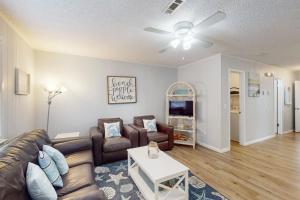 a living room with a couch and a table at Dog-friendly duplex 2 blocks from beach with private yard AC & W&D in Panama City Beach +31 photos