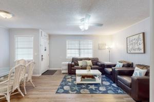 a living room with a couch and a table at Dog-friendly duplex 2 blocks from beach with private yard AC & W&D in Panama City Beach