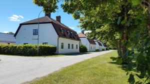 a row of white houses on a street at Lägenhet Strömsberg C in Strömsberg