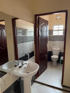 a bathroom with a sink and a toilet at Kristina Gardens in Voi +64 photos