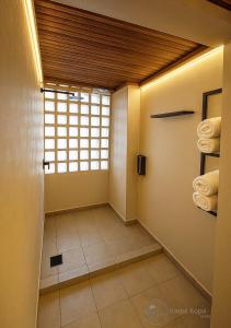 a bathroom with a window and towels in it at Irama Kopa - Glory Beach Resort in Port Dickson
