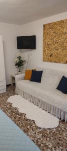 a bedroom with a bed with a tv on the wall at Casa dei sospiri in Polignano a Mare