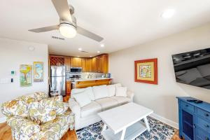 a living room with a couch and a table at Cozy top-floor beachfront condo with pool pool spa & beach access in Perdido Key