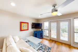 a living room with a couch and a table at Cozy top-floor beachfront condo with pool pool spa & beach access in Perdido Key