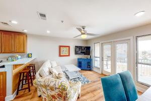 a living room with a couch and a table at Cozy top-floor beachfront condo with pool pool spa & beach access in Perdido Key