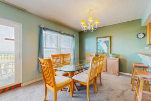 a dining room with a glass table and chairs at Beautiful beachfront condo with shared pool & beach access in Fort Walton Beach
