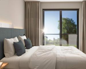 a bedroom with a large white bed with a large window at Engels Traumwerk in Wertach +7 photos