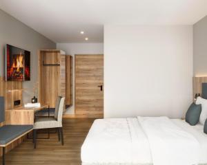 a bedroom with a bed and a desk and a table at Engels Traumwerk in Wertach