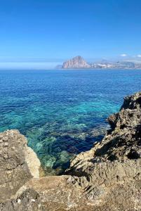 a view of the ocean from a rocky cliff at CasAmare in Pizzolungo