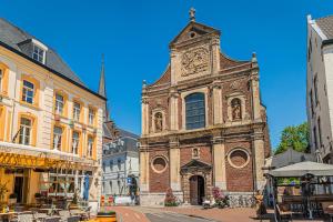 an old building with a clock tower on a street at DoubleTree by Hilton Sittard in Sittard