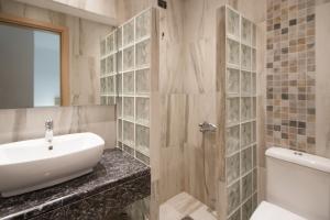 a bathroom with a sink and a toilet and a shower at Villa Alissia in Koukounaries +24 photos