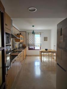 a kitchen with a table and a dining room at La Casa Sahi in Gáldar