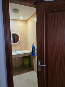 a bathroom with a sink and a mirror at La Casa Sahi in Gáldar +11 photos