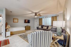 a living room with a couch and a bed at Beautiful coastal studio condo with pool in Santa Rosa Beach