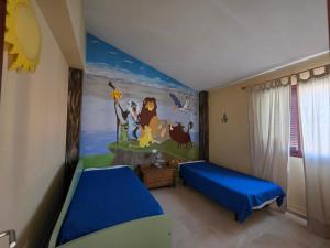 a bedroom with two beds and a mural of a cartoon at La Casa Sahi in Gáldar