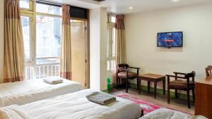 a hotel room with two beds and a window at Nextdoor Thamel in Kathmandu