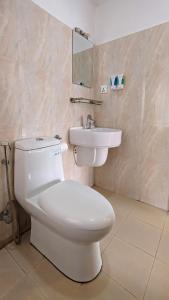 a bathroom with a white toilet and a sink at Nextdoor Thamel in Kathmandu +53 photos