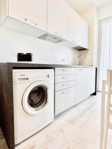 a white laundry room with a washer and dryer at Milano Suite Francine in Milan